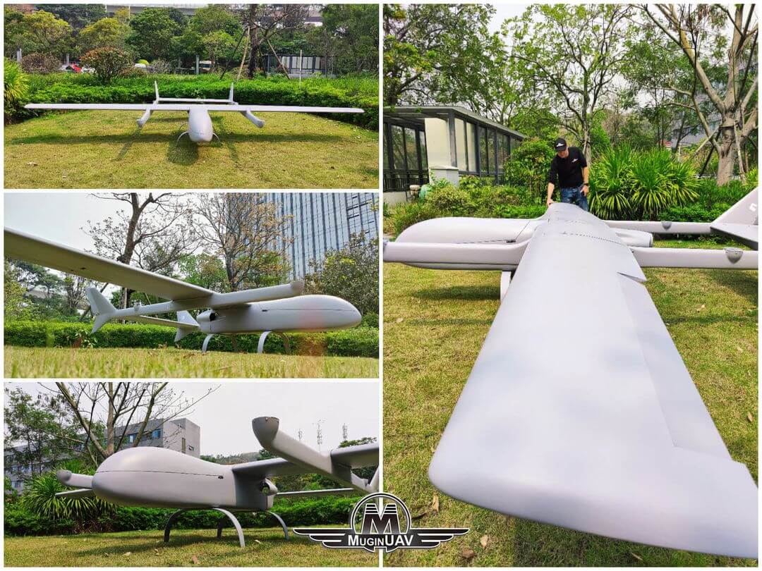 Grey UAV aircraft on grassy field.